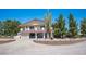 Two-story home with large trees and cacti in a rock garden at 1106 E Athens Ave, Henderson, NV 89015