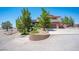 Two-story home with a two car garage, rock landscaping, and mature trees at 1106 E Athens Ave, Henderson, NV 89015