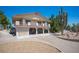 Two-story home featuring a balcony and a charming, landscaped yard with gravel and mature trees at 1106 E Athens Ave, Henderson, NV 89015