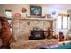 Cozy stone fireplace with wood-burning stove insert and custom carved wooden bear accents at 1106 E Athens Ave, Henderson, NV 89015