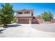 Exterior view of the two-story home with two-car garage, and a long driveway at 1106 E Athens Ave, Henderson, NV 89015