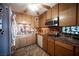 Compact kitchen with light wood cabinetry and modern appliances at 1106 E Athens Ave, Henderson, NV 89015