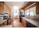 Charming kitchen featuring wood cabinets, tiled floors, modern appliances, and natural light at 1106 E Athens Ave, Henderson, NV 89015