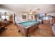 Open-concept living room with terracotta floors, a pool table, and dining area for seamless entertaining at 1106 E Athens Ave, Henderson, NV 89015
