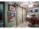 Charming home office featuring rustic sliding barn doors and a decorative ceiling fan at 1106 E Athens Ave, Henderson, NV 89015