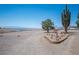 Spacious lot with decorative windmill accents and native desert landscaping, showcasing open views at 1106 E Athens Ave, Henderson, NV 89015