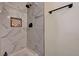 Updated bathroom with a rainfall showerhead, white tile and black hardware at 1804 David Ave, Las Vegas, NV 89101