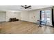 Bright, open living room features wood-look floors, modern ceiling fan, and dining area near natural light at 1804 David Ave, Las Vegas, NV 89101