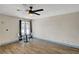 Bright living area featuring hardwood floors, table and chairs, a ceiling fan and large window at 1804 David Ave, Las Vegas, NV 89101