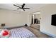 This main bedroom features a ceiling fan, carpet flooring and a TV at 1804 David Ave, Las Vegas, NV 89101
