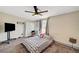 This main bedroom features a ceiling fan, carpet flooring and a TV at 1804 David Ave, Las Vegas, NV 89101