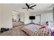 This main bedroom features a ceiling fan, carpet flooring and a TV at 1804 David Ave, Las Vegas, NV 89101