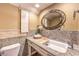Charming powder room with decorative mirror, elegant fixtures, granite counters, and a unique vanity at 1844 Winners Cup Drive, Las Vegas, NV 89117