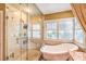 Bright bathroom featuring a separate shower, freestanding tub, and modern fixtures with window at 1844 Winners Cup Drive, Las Vegas, NV 89117