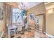 Beautiful dining room with a chandelier, mirrored accent wall, and a large window with plantation shutters at 1844 Winners Cup Drive, Las Vegas, NV 89117