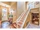 Grand entryway featuring a staircase, chandelier, and stylish decor with views to adjacent rooms at 1844 Winners Cup Drive, Las Vegas, NV 89117