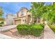 Two-story home showcases a well-kept lawn and a lovely stone walkway leading to the front door at 1844 Winners Cup Drive, Las Vegas, NV 89117