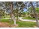 Scenic greenbelt view featuring mature trees, a charming bridge, and well-maintained landscaping at 1844 Winners Cup Drive, Las Vegas, NV 89117