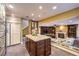 Open kitchen with a large island, granite counters, modern appliances, and seamless integration into living area at 1844 Winners Cup Drive, Las Vegas, NV 89117