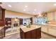 Gourmet kitchen with an island, granite countertops, custom cabinets, and a view to the living room at 1844 Winners Cup Drive, Las Vegas, NV 89117