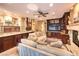 Open living room featuring built-in cabinetry, a fireplace, seamless integration into the kitchen, and comfortable seating at 1844 Winners Cup Drive, Las Vegas, NV 89117