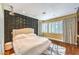 Stylish bedroom features a 3D accent wall, hardwood floors, plantation shutters, and a comfortable bed at 1844 Winners Cup Drive, Las Vegas, NV 89117