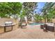 Inviting pool area with a built-in grill, egg chair, and lounge seating, perfect for outdoor entertaining at 1844 Winners Cup Drive, Las Vegas, NV 89117