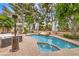 Beautiful pool area featuring a waterfall, lounge seating, and lush landscaping for a relaxing outdoor experience at 1844 Winners Cup Drive, Las Vegas, NV 89117