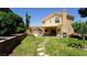 Lush backyard with green lawn, stepping stones, and a covered patio area at 2017 Shining Feather Ln, Las Vegas, NV 89134