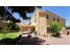 Backyard featuring a covered patio, mature trees, and low-maintenance landscaping at 2017 Shining Feather Ln, Las Vegas, NV 89134