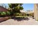 Lush backyard featuring mature trees, green lawn, and covered patio area at 2017 Shining Feather Ln, Las Vegas, NV 89134