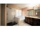 Bathroom featuring a glass-enclosed shower, soaking tub, double vanity, and large mirror at 2017 Shining Feather Ln, Las Vegas, NV 89134