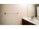 Neutral half-bathroom with marble-style countertop and wood cabinet at 2017 Shining Feather Ln, Las Vegas, NV 89134