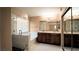 Bathroom featuring a glass-enclosed shower, soaking tub, double vanity, and large mirror at 2017 Shining Feather Ln, Las Vegas, NV 89134