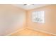 This bedroom has a ceiling fan, and a window that lets in natural light over the hardwood flooring at 2017 Shining Feather Ln, Las Vegas, NV 89134