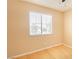 This bedroom has a ceiling fan, and a window that lets in natural light over the hardwood flooring at 2017 Shining Feather Ln, Las Vegas, NV 89134