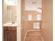 Hallway view of a bathroom with a light-colored vanity at 2017 Shining Feather Ln, Las Vegas, NV 89134
