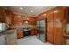 Well-lit kitchen featuring stainless steel appliances, granite countertops, and wood cabinets at 2017 Shining Feather Ln, Las Vegas, NV 89134