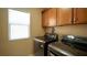 Convenient laundry area with modern washer and dryer set and wood storage cabinets at 2017 Shining Feather Ln, Las Vegas, NV 89134