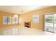 Bright, tiled living room with a fireplace, slider door, and several windows at 2017 Shining Feather Ln, Las Vegas, NV 89134