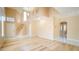 Spacious living room with high ceilings, staircase, and a blend of wood and tile flooring at 2017 Shining Feather Ln, Las Vegas, NV 89134