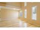 Open living area with tall windows providing ample natural light and hardwood flooring at 2017 Shining Feather Ln, Las Vegas, NV 89134