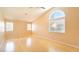 Spacious main bedroom with vaulted ceiling, wood floors, and bright windows at 2017 Shining Feather Ln, Las Vegas, NV 89134
