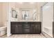 Bathroom with double vanity, undermount sinks, framed mirrors, and a glass enclosed walk-in shower at 209 Bennett Pointe Ave, Henderson, NV 89011