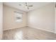 Bright bedroom featuring tile floors, a ceiling fan, and a window that provides ample light at 209 Bennett Pointe Ave, Henderson, NV 89011