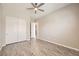 Well-lit bedroom with tile floors, a closet and an entry door, and a modern ceiling fan at 209 Bennett Pointe Ave, Henderson, NV 89011