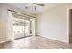 Bright bedroom with wood-look flooring and sliding glass doors to the outdoor patio at 209 Bennett Pointe Ave, Henderson, NV 89011