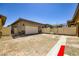 Spacious driveway leading to a two-car garage, accented with pavers and desert landscaping at 209 Bennett Pointe Ave, Henderson, NV 89011