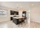 Modern kitchen features a large island with granite countertops, stainless steel appliances, and dark cabinetry at 209 Bennett Pointe Ave, Henderson, NV 89011