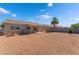 View of a large backyard with a gravel ground cover and a block wall at 2111 Hollow Oak Ave, North Las Vegas, NV 89031